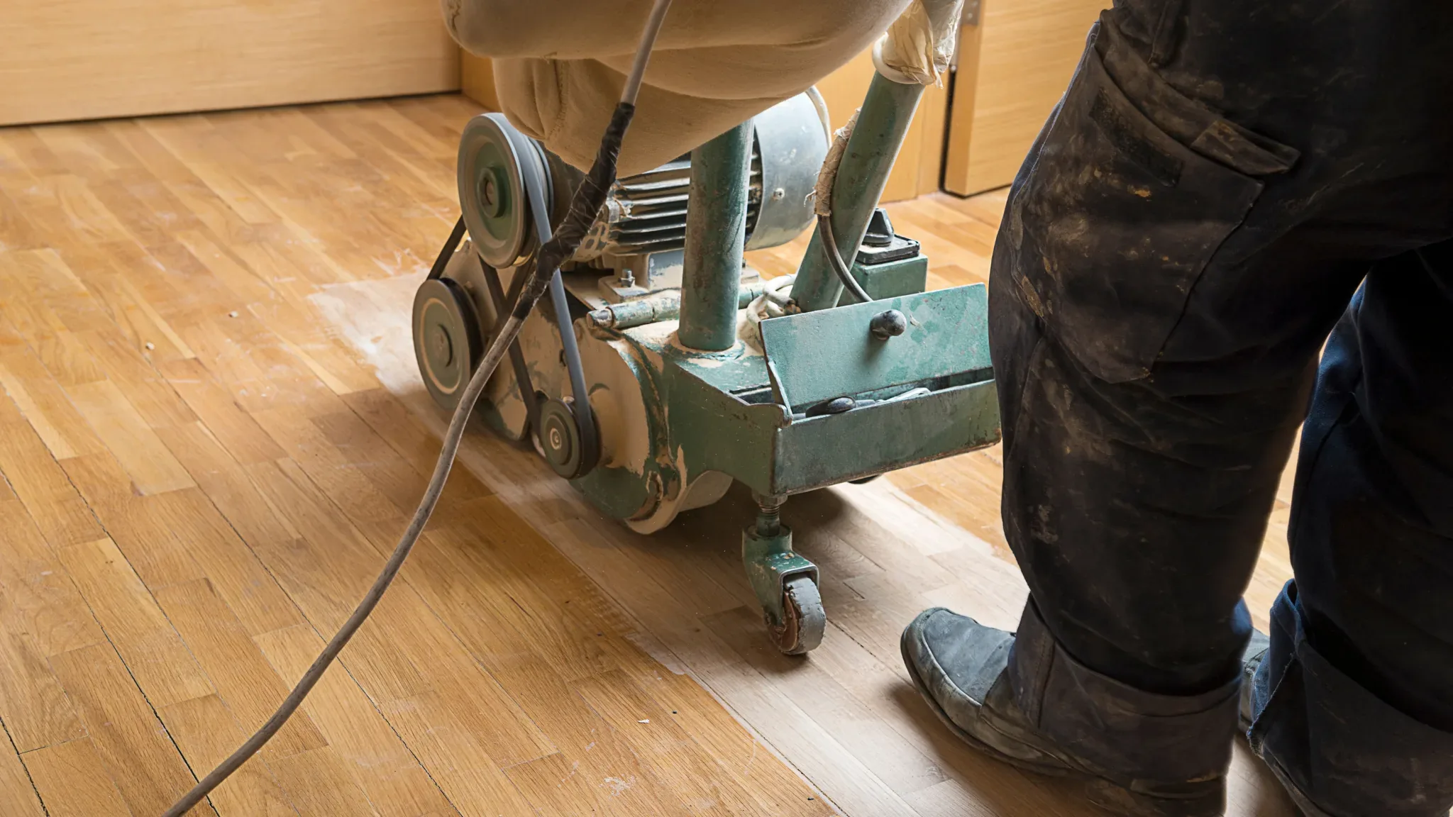 Professional floor sanding and refinishing equipment in operation on hardwood flooring during a restoration project.